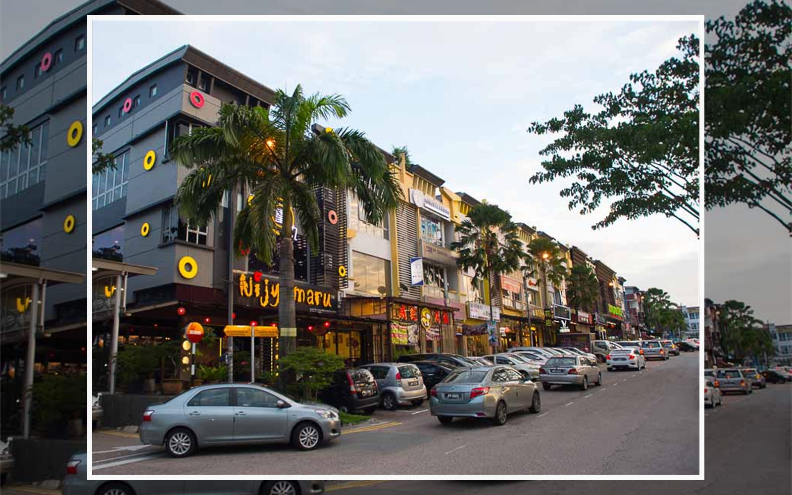 Taman Sutera Sutera Utama shop row street with restaurants and parked cars for JB food trip planning